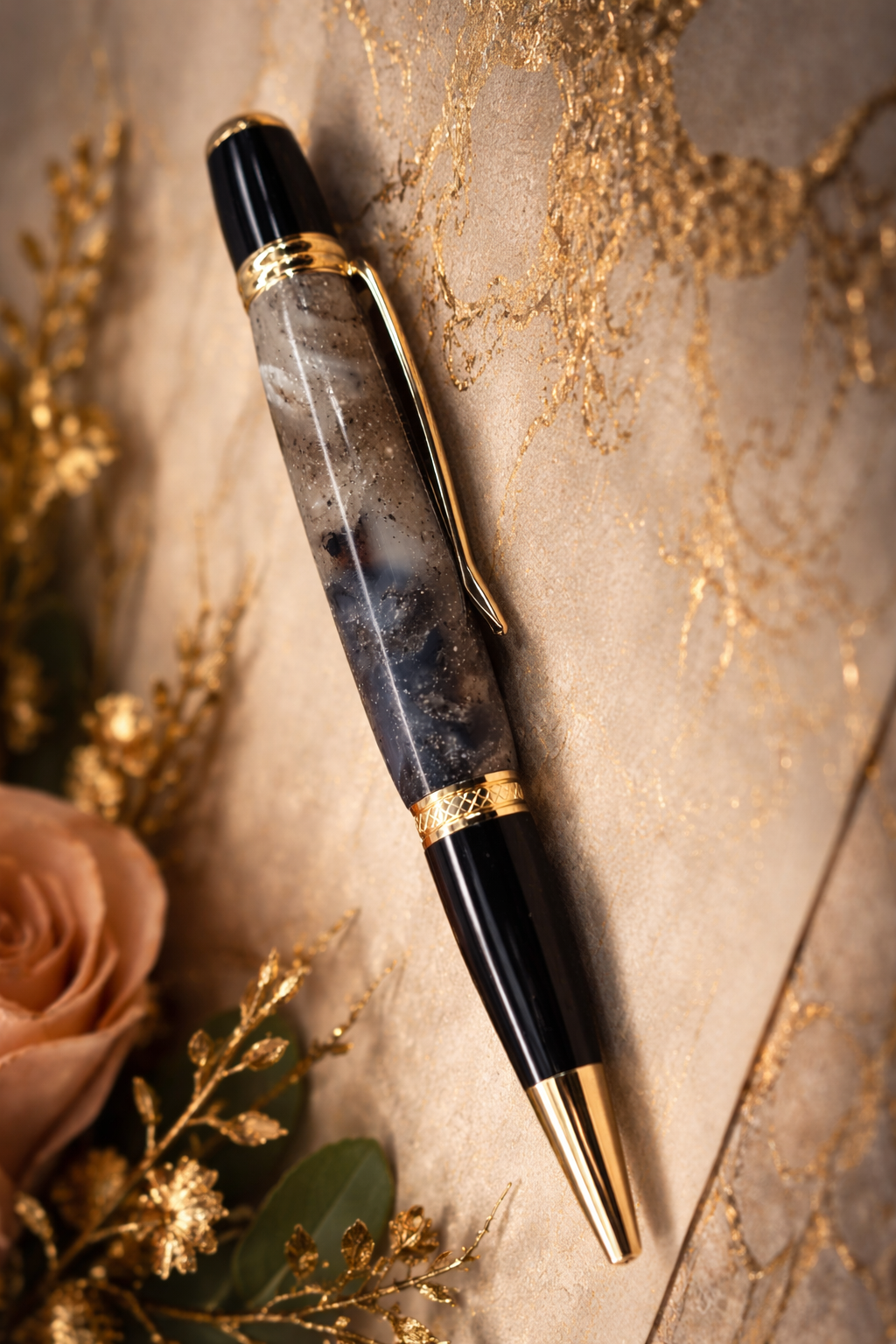 Luxury pen with gold accents on a decorative surface with flowers