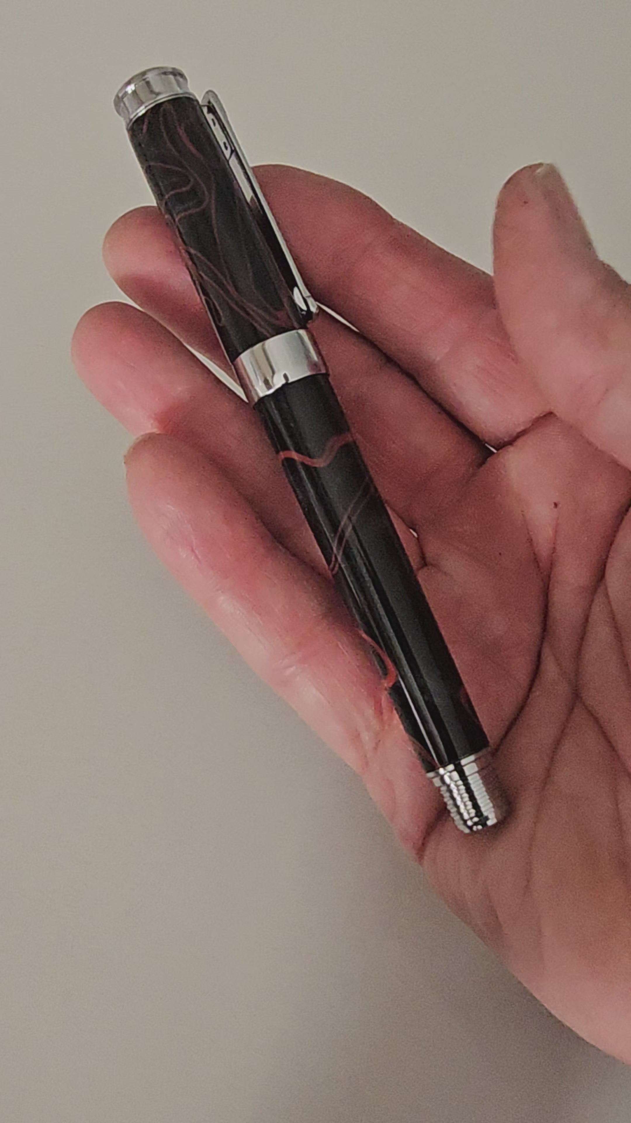 The Cosmic Fire Fountain Pen.  Forged from "Supernova" resin with a gold-plated nib, this unique celestial tool turns every word into a work of art.