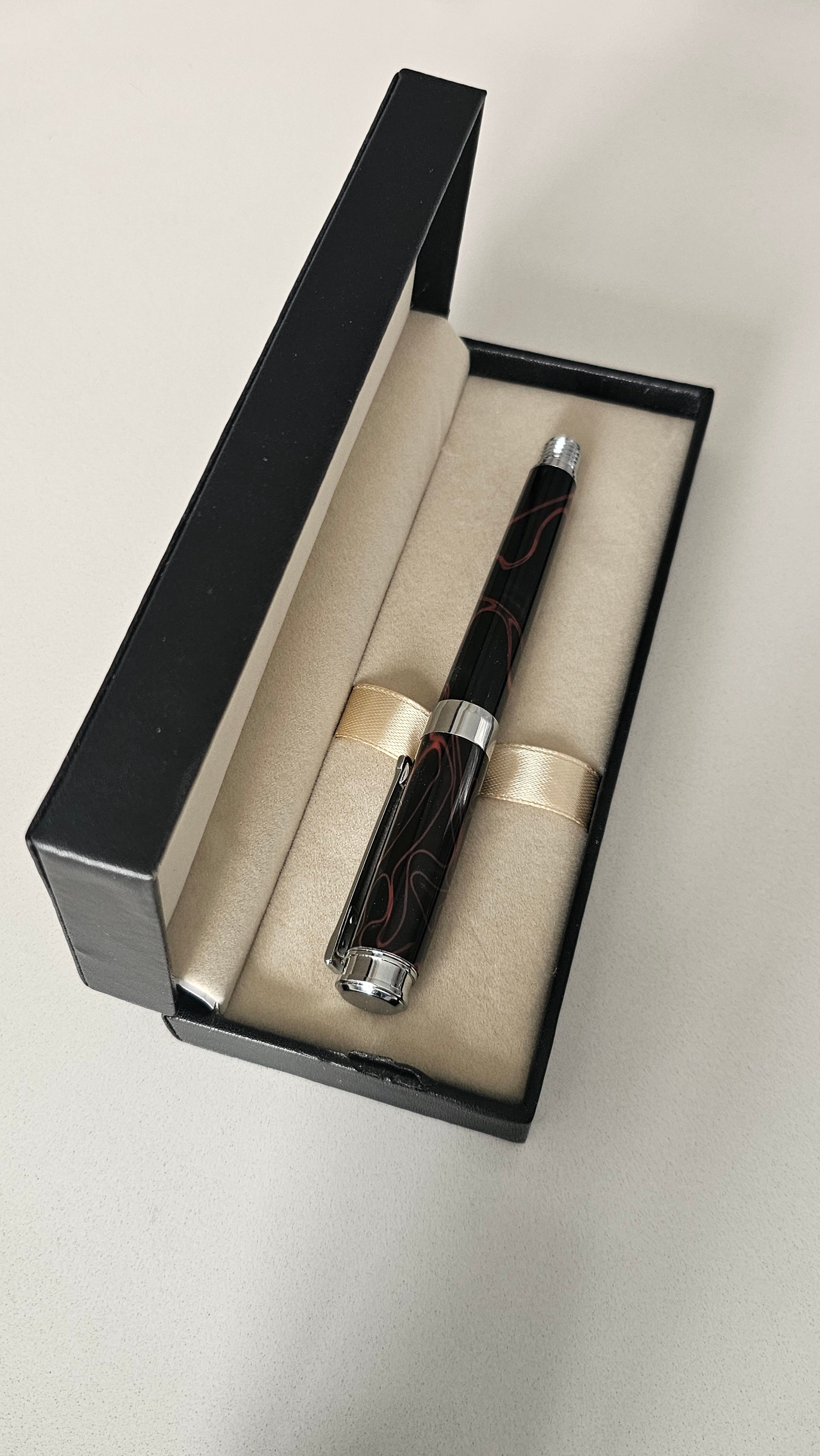The Cosmic Fire Fountain Pen.  Forged from "Supernova" resin with a gold-plated nib, this unique celestial tool turns every word into a work of art.