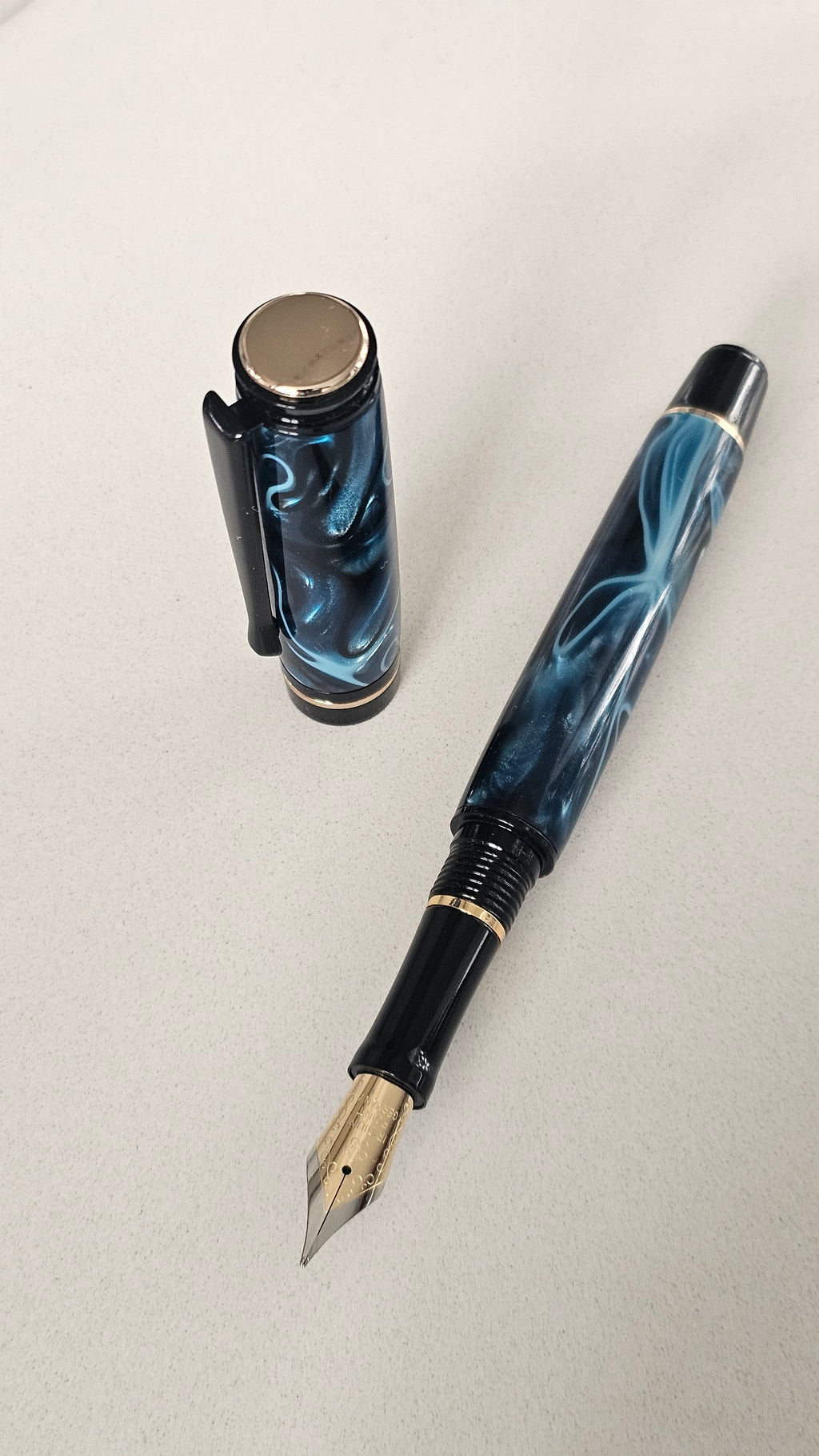 Blue Nebula Fountain Pen. Hand-turned with a deep blue and shimmering silver acrylic resin .