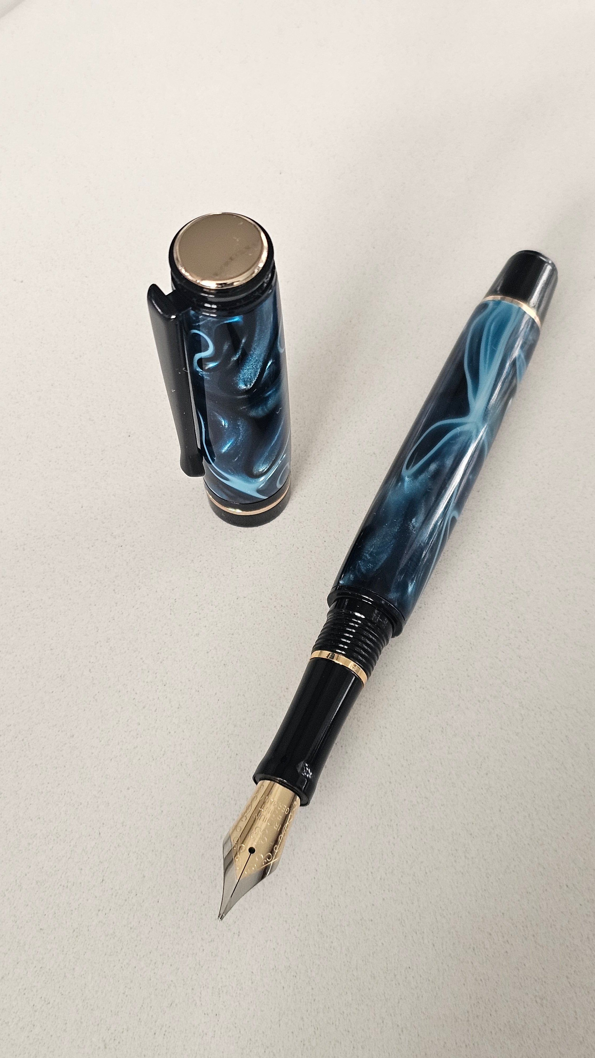 Blue Nebula Fountain Pen. Hand-turned with a deep blue and shimmering silver acrylic resin .