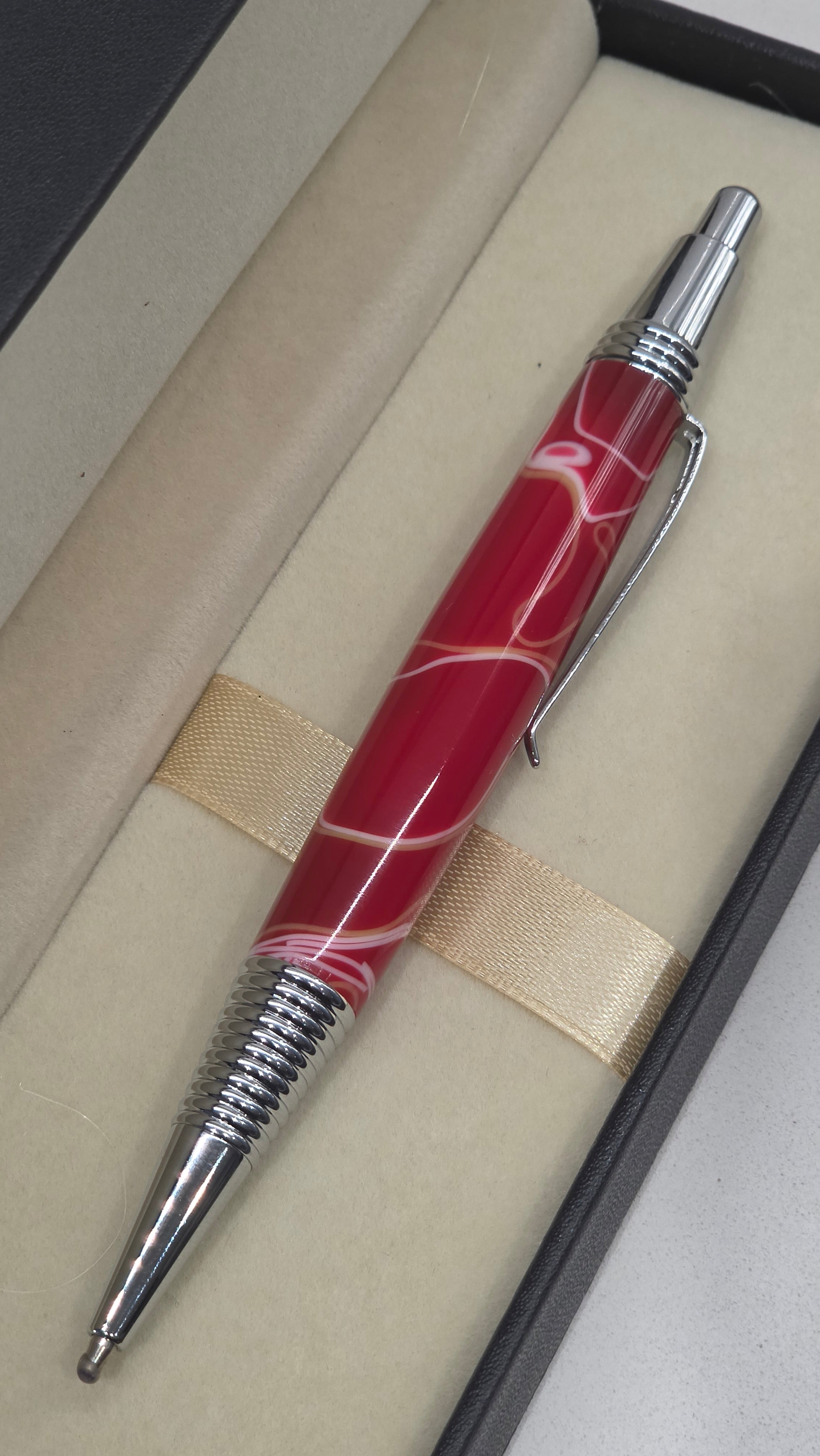 Red and White hand turned resin click rollerball pen.