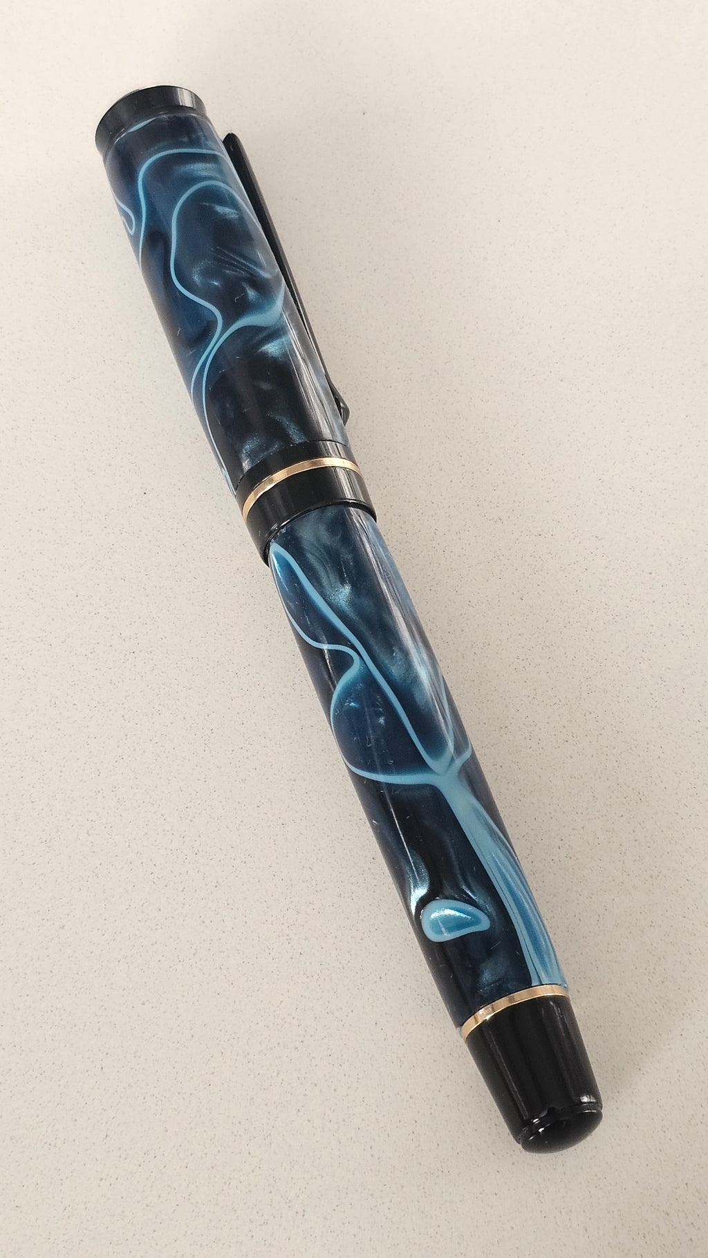 Blue Nebula Fountain Pen. Hand-turned with a deep blue and shimmering silver acrylic resin .