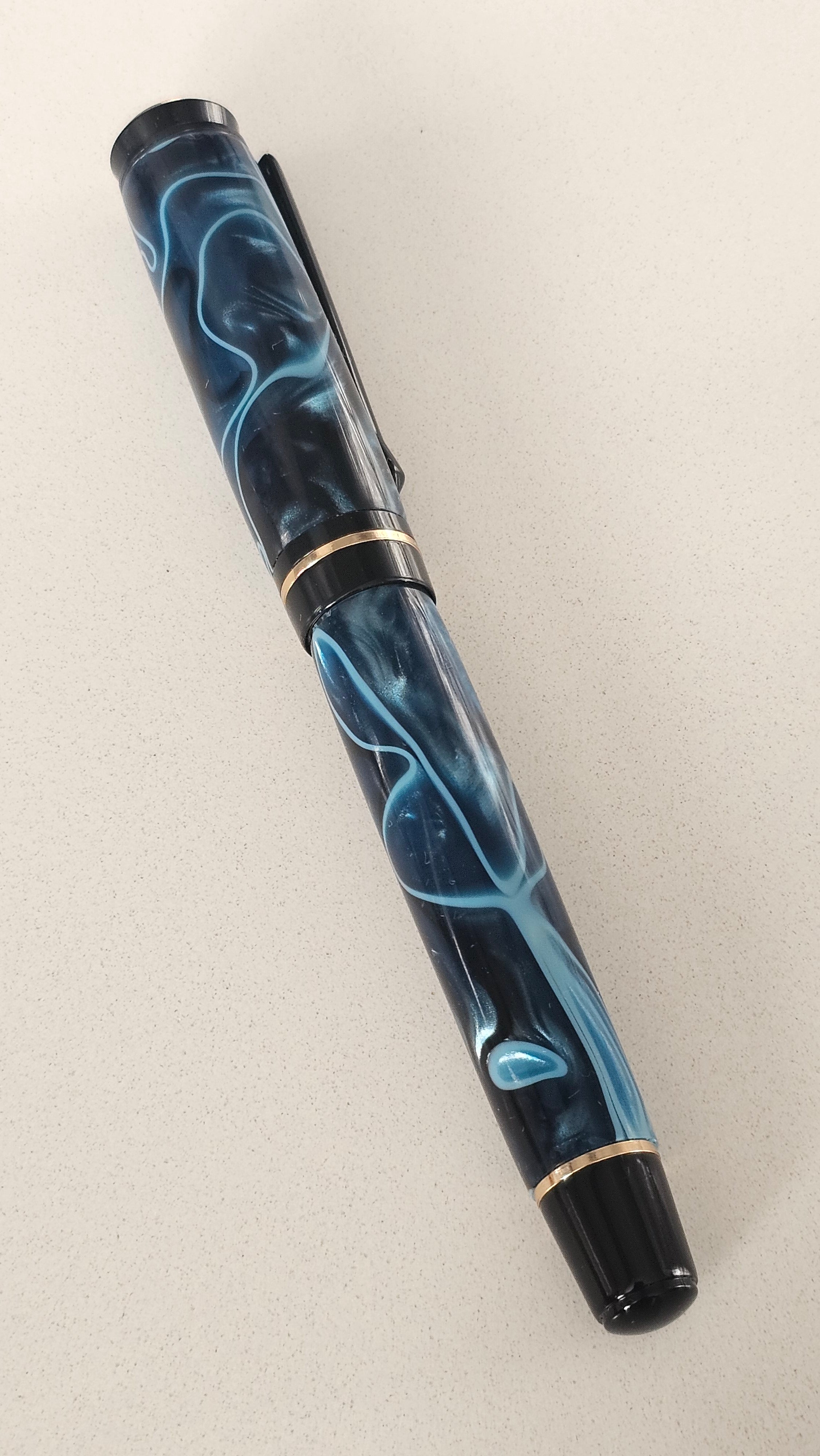 Blue Nebula Fountain Pen. Hand-turned with a deep blue and shimmering silver acrylic resin .
