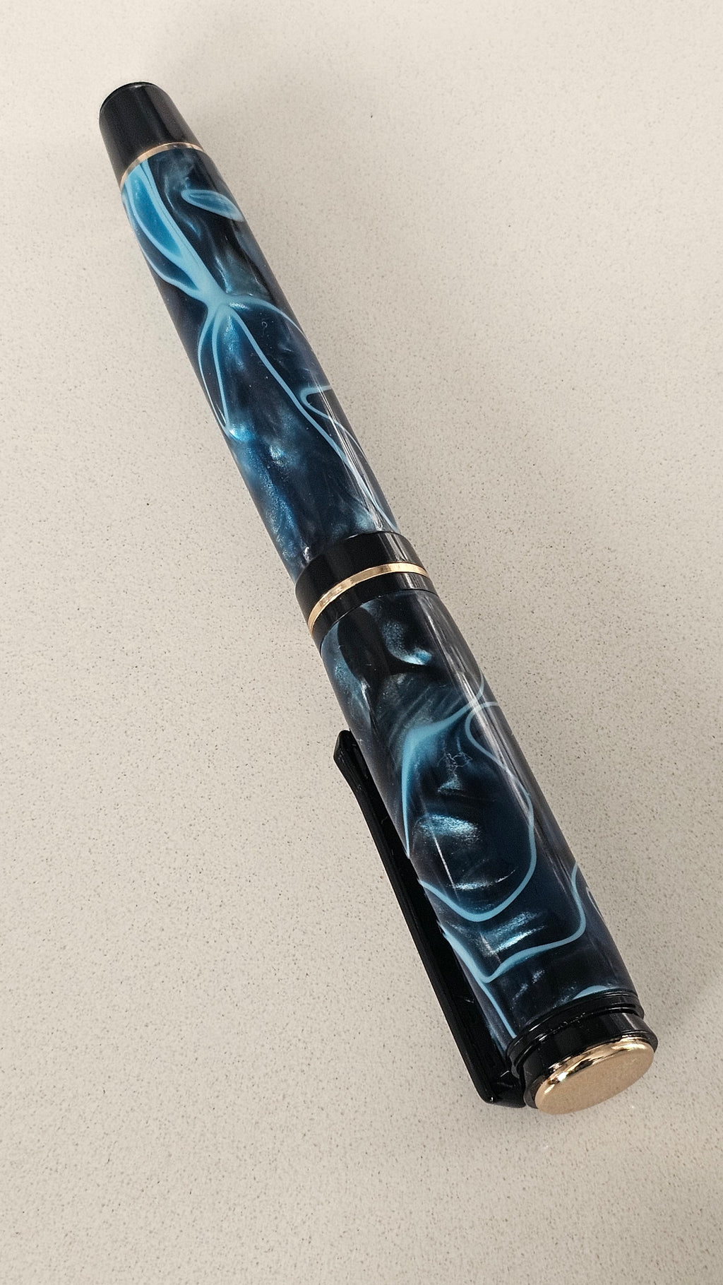Blue Nebula Fountain Pen. Hand-turned with a deep blue and shimmering silver acrylic resin .