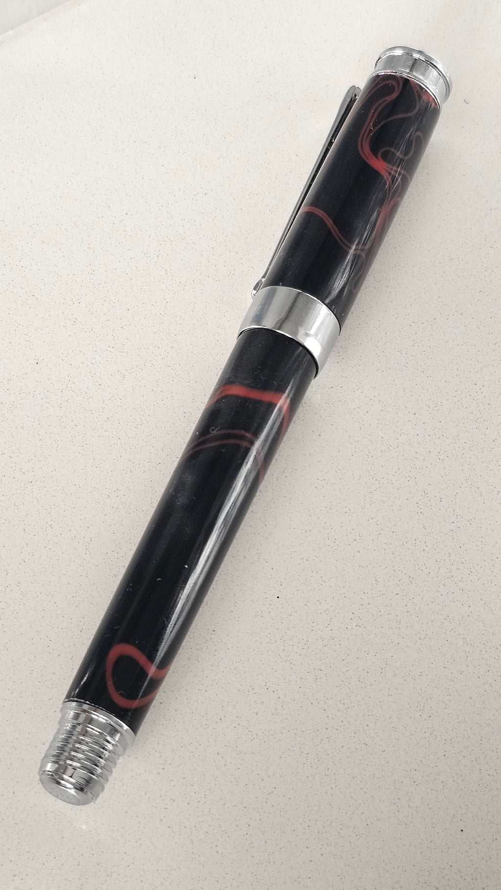 The Cosmic Fire Fountain Pen.  Forged from "Supernova" resin with a gold-plated nib, this unique celestial tool turns every word into a work of art.