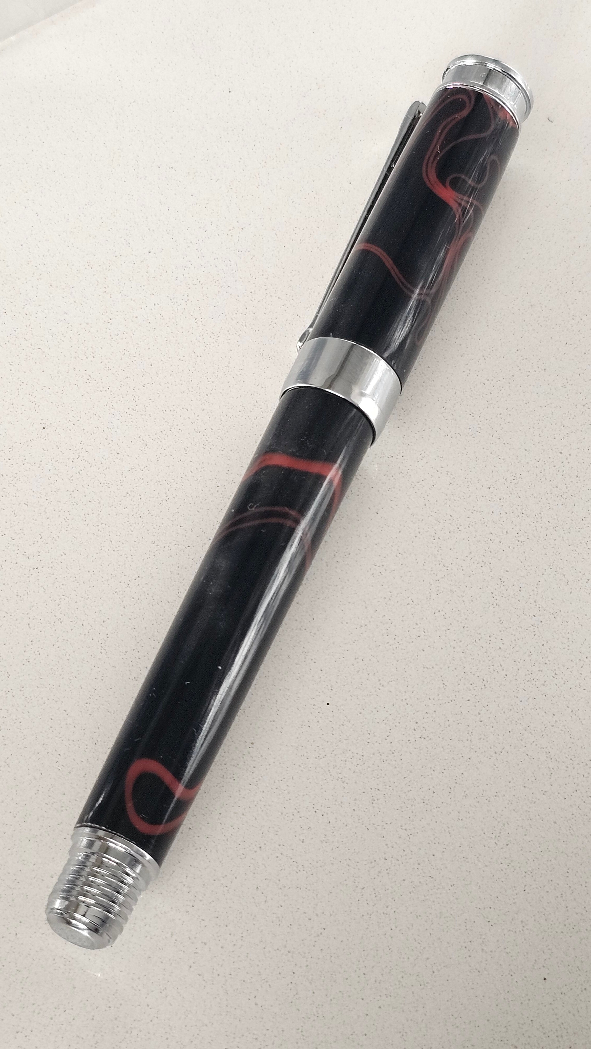 The Cosmic Fire Fountain Pen.  Forged from "Supernova" resin with a gold-plated nib, this unique celestial tool turns every word into a work of art.