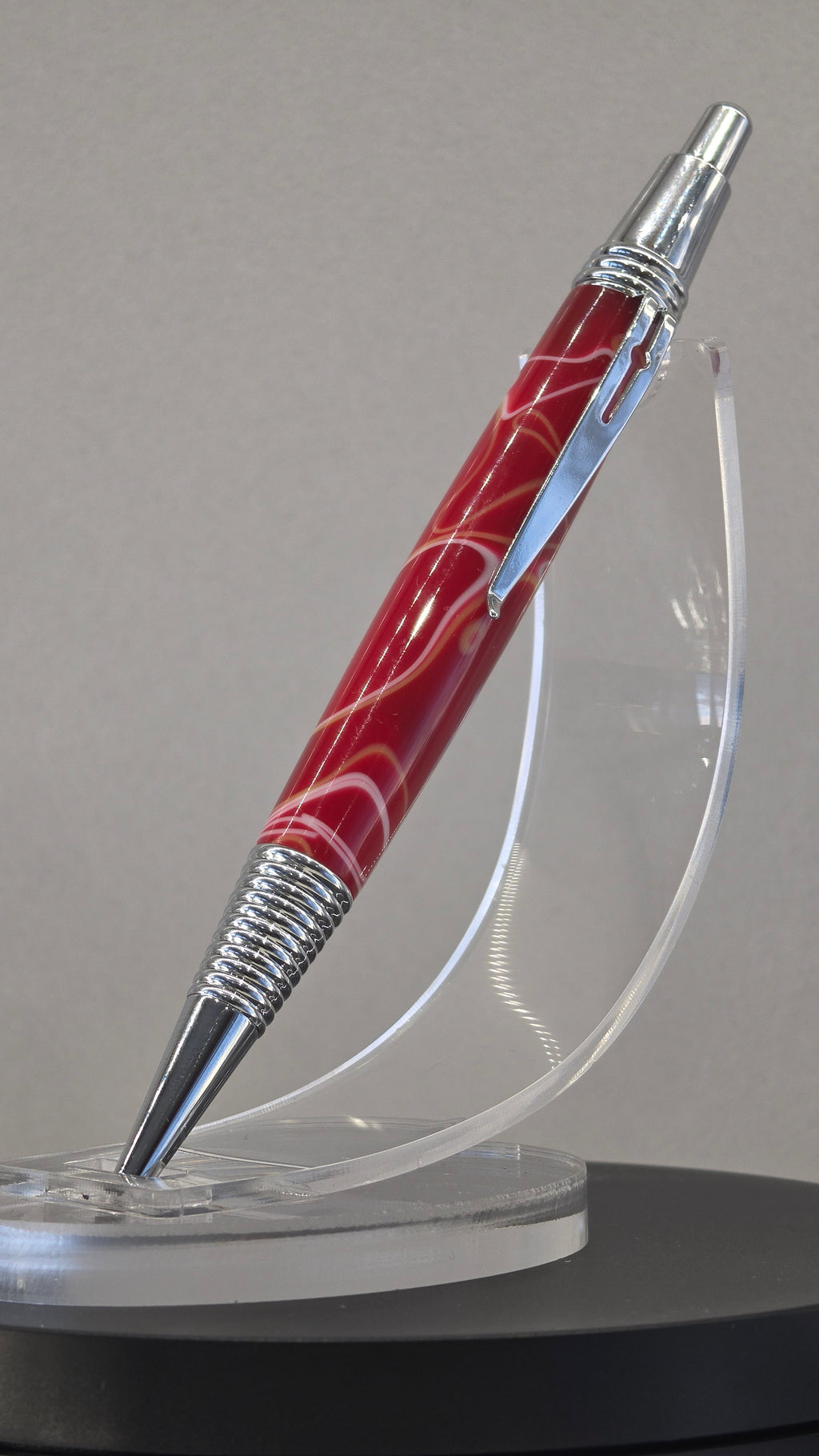 Red and White hand turned resin click rollerball pen.