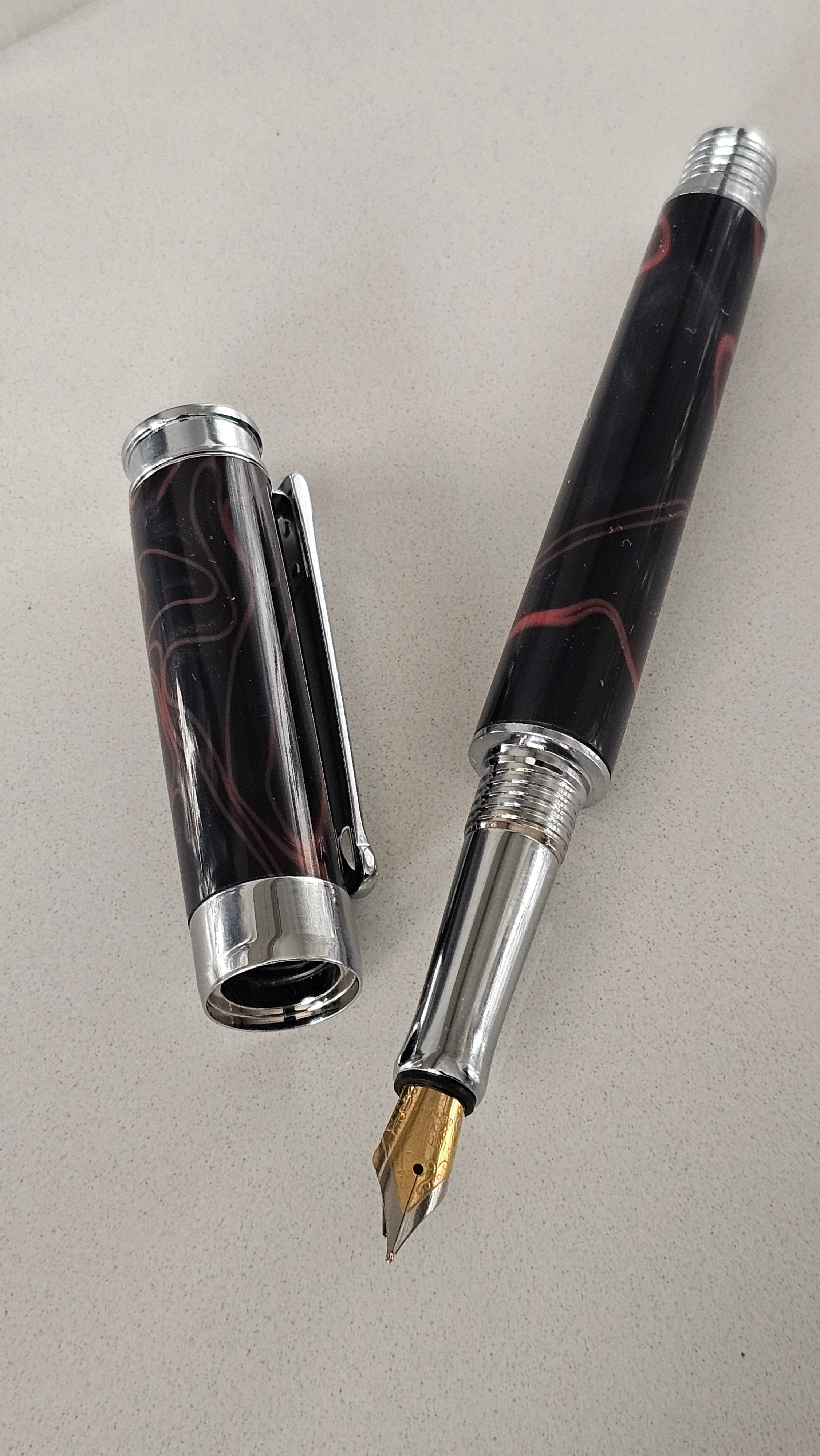 The Cosmic Fire Fountain Pen.  Forged from "Supernova" resin with a gold-plated nib, this unique celestial tool turns every word into a work of art.
