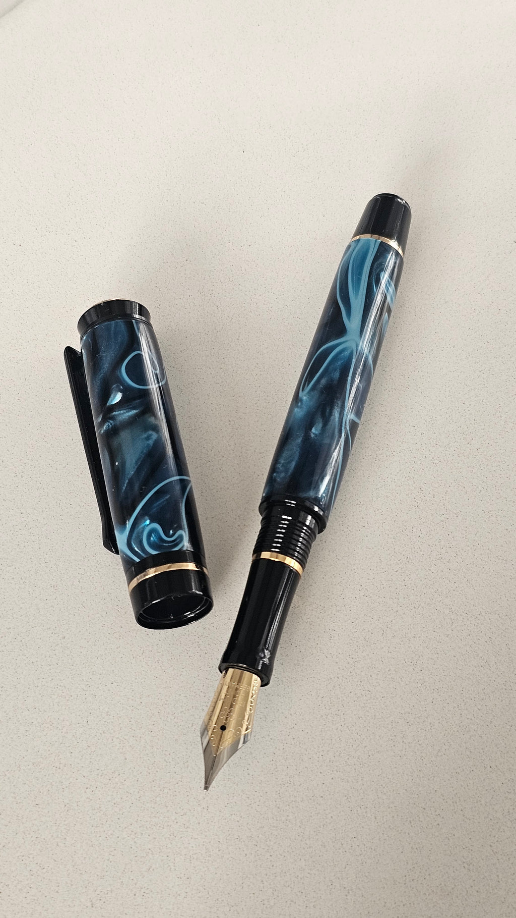 Blue Nebula Fountain Pen. Hand-turned with a deep blue and shimmering silver acrylic resin .