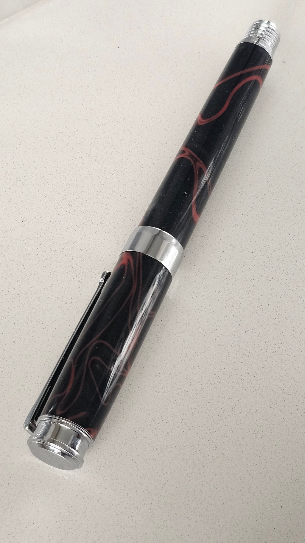The Cosmic Fire Fountain Pen.  Forged from "Supernova" resin with a gold-plated nib, this unique celestial tool turns every word into a work of art.