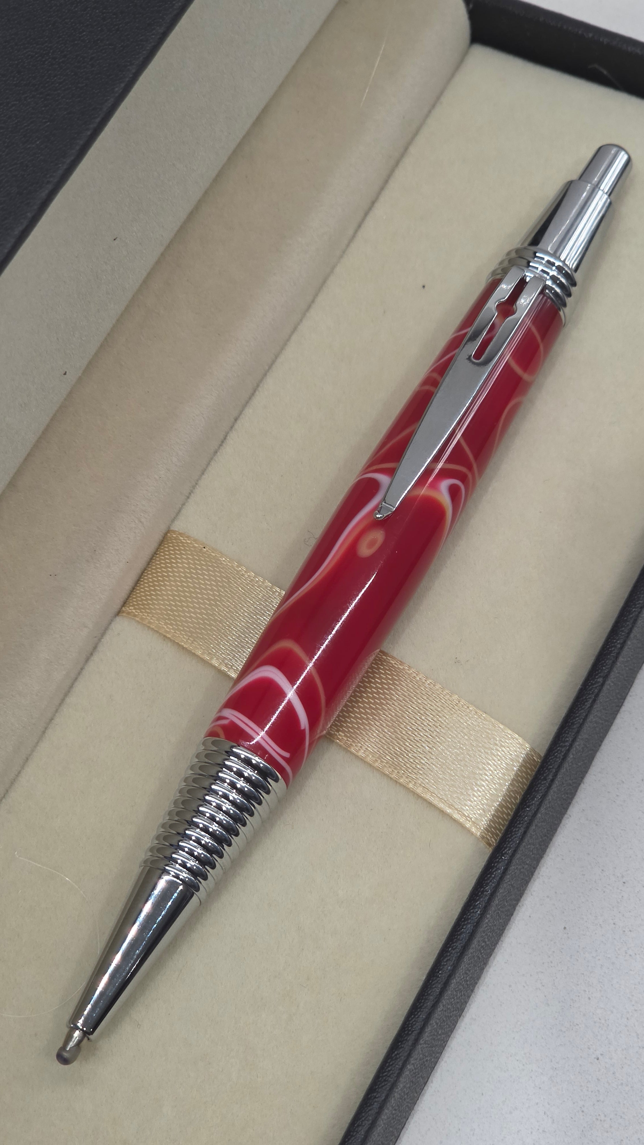 Red and White hand turned resin click rollerball pen.