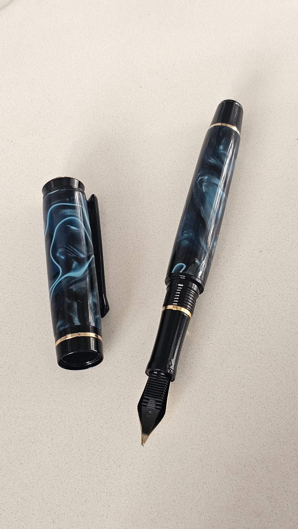 Blue Nebula Fountain Pen. Hand-turned with a deep blue and shimmering silver acrylic resin .