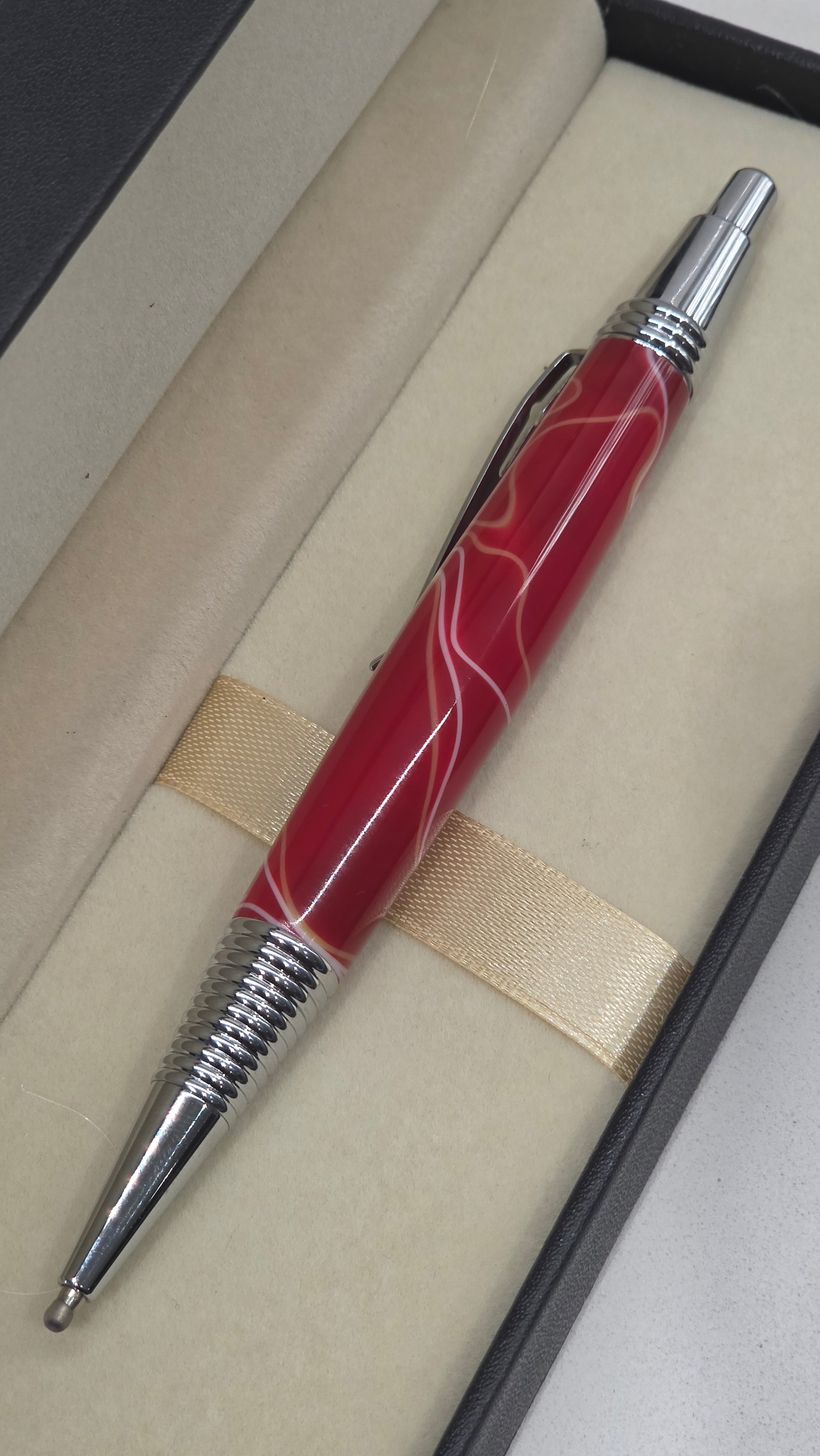 Red and White hand turned resin click rollerball pen.