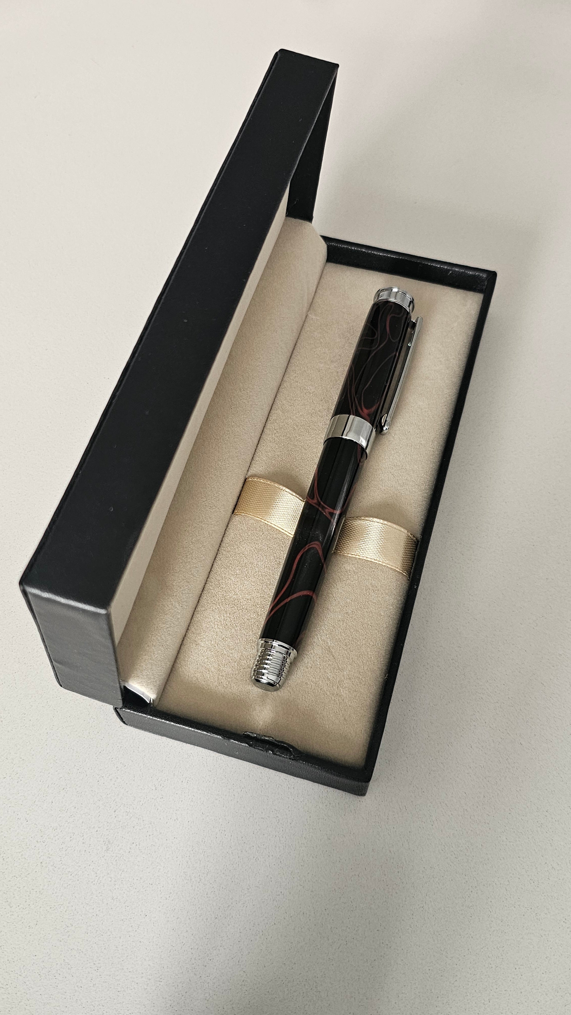 The Cosmic Fire Fountain Pen.  Forged from "Supernova" resin with a gold-plated nib, this unique celestial tool turns every word into a work of art.