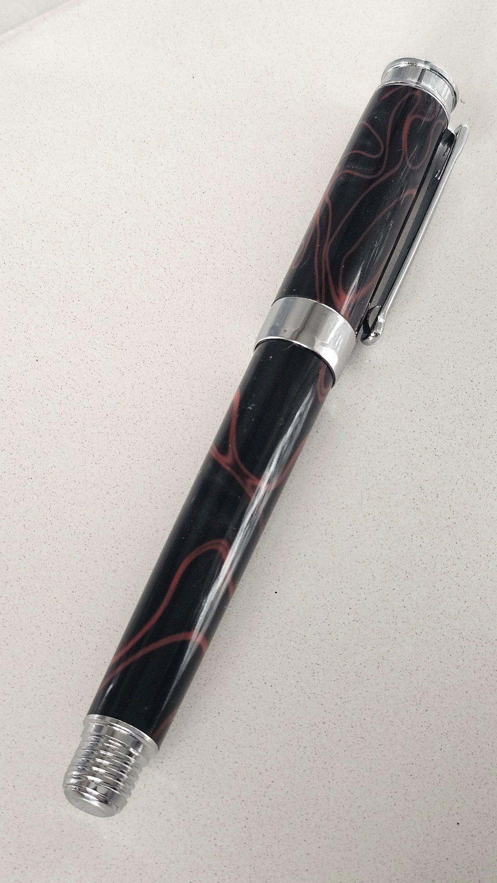 The Cosmic Fire Fountain Pen.  Forged from "Supernova" resin with a gold-plated nib, this unique celestial tool turns every word into a work of art.