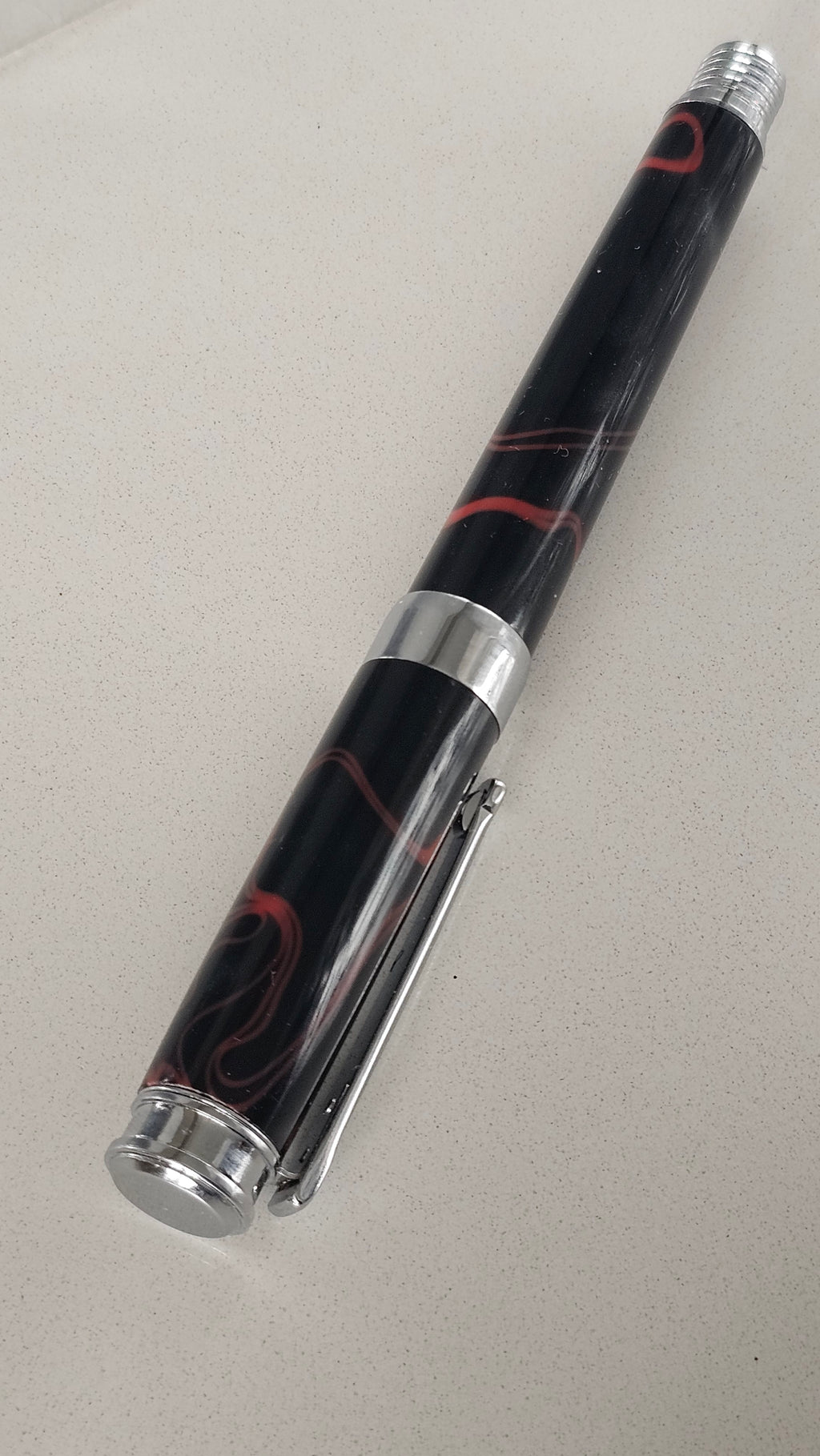 The Cosmic Fire Fountain Pen.  Forged from "Supernova" resin with a gold-plated nib, this unique celestial tool turns every word into a work of art.