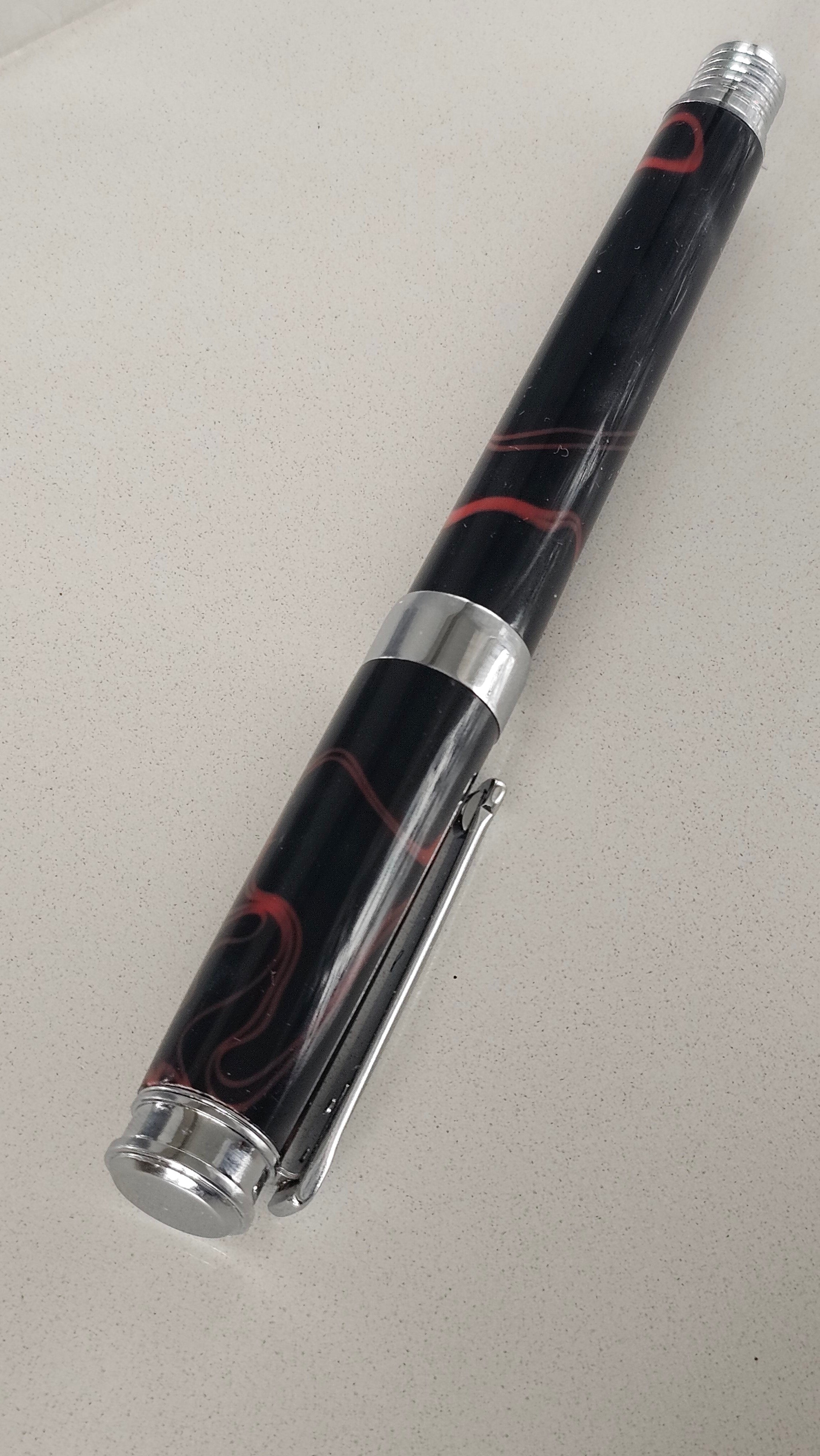 The Cosmic Fire Fountain Pen.  Forged from "Supernova" resin with a gold-plated nib, this unique celestial tool turns every word into a work of art.